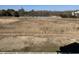 View of a vacant lot with a partial view of a pond surrounded by a white fence and natural foliage at 1207 Salt Windy Way, North Myrtle Beach, SC 29582
