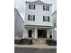 Three-story home features siding, black shutters, front-facing garage and entry, and a flat roofline at 1310 Battery Park Dr., North Myrtle Beach, SC 29582