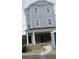 Three-story home featuring an attached two car garage and a covered front porch at 1312 Battery Park Dr., North Myrtle Beach, SC 29582