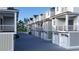 Side view of townhouses, highlighting the garages and landscaping at 202-B Madison Ct., Myrtle Beach, SC 29577