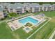 Aerial view of pool area with chairs, tables and umbrellas, alongside a hot tub and manicured lawns at 606 Waterway Village Blvd. # 28-C, Myrtle Beach, SC 29579