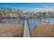 Stunning waterfront view with a long dock and waterfront homes in the background at 606 Waterway Village Blvd. # 28-C, Myrtle Beach, SC 29579