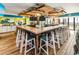 Unique bar with wood accents, overhead lighting, televisions, and bar stool seating at 2401 S Ocean Blvd. # 1156, Myrtle Beach, SC 29577