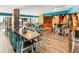 Dining area with multiple tables, chairs, and surfboards displayed along the wall at 2401 S Ocean Blvd. # 1156, Myrtle Beach, SC 29577