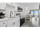 Modern kitchen featuring stainless steel appliances, quartz countertops, and open dining area at 2401 S Ocean Blvd. # 1156, Myrtle Beach, SC 29577