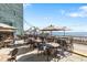Outdoor dining area with tables, chairs, and umbrellas overlooking the ocean and beach providing an enjoyable experience at 2401 S Ocean Blvd. # 1156, Myrtle Beach, SC 29577