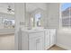 Bright bathroom features double sink vanity, frameless shower, and modern finishes with natural light at 2307 Tortuga Ln., North Myrtle Beach, SC 29582