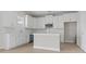 Bright kitchen features white cabinets, modern appliances, and an island with countertop seating at 2307 Tortuga Ln., North Myrtle Beach, SC 29582