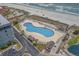 Aerial view of a pool and oceanfront condo with beach access and plenty of lounge chairs at 5905 S Kings Highway # 1117, Myrtle Beach, SC 29575