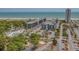 An aerial view shows a vibrant coastal resort with multiple buildings, a pool, and a sandy beach nearby at 5905 S Kings Highway # 1117, Myrtle Beach, SC 29575