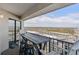 Balcony with table and chairs overlooking a tree-lined cityscape and the ocean at 5905 S Kings Highway # 1117, Myrtle Beach, SC 29575
