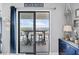 Balcony with sliding glass doors showcasing beach house sign and blue furnishings at 5905 S Kings Highway # 1117, Myrtle Beach, SC 29575