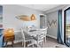 Dining area features a white table with seating for four and beach themed wall decor at 5905 S Kings Highway # 1117, Myrtle Beach, SC 29575
