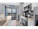 Bright kitchen with stainless steel appliances and sliding door access to a beachfront balcony at 5905 S Kings Highway # 1117, Myrtle Beach, SC 29575