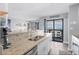 Open concept kitchen with granite countertops and views of the dining and beachfront balcony at 5905 S Kings Highway # 1117, Myrtle Beach, SC 29575