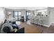 Bright living room with ocean views from the balcony, open to the kitchen with bar stool seating at 5905 S Kings Highway # 1117, Myrtle Beach, SC 29575