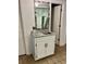 Bathroom vanity with a decorative mirror, granite countertop, and white cabinetry at 6000 N Ocean Blvd. # 131, North Myrtle Beach, SC 29582