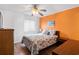 Bright bedroom features a queen bed with a colorful quilt, fan, and tropical decor at 6000 N Ocean Blvd. # 131, North Myrtle Beach, SC 29582