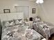 Guest bedroom featuring two twin beds, neutral coastal decor, and window at 6000 N Ocean Blvd. # 131, North Myrtle Beach, SC 29582