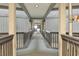 Wide hallway with gray railings and a carpeted floor, leading to stairs at 6000 N Ocean Blvd. # 131, North Myrtle Beach, SC 29582
