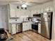Clean, fully-equipped condo kitchen featuring white cabinets and stainless steel appliances at 6000 N Ocean Blvd. # 131, North Myrtle Beach, SC 29582