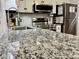 Close-up of the condo's kitchen with granite countertops and stainless steel appliances at 6000 N Ocean Blvd. # 131, North Myrtle Beach, SC 29582