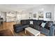 Bright living room with a large sectional sofa, light wood floors, and a view of the kitchen at 6000 N Ocean Blvd. # 131, North Myrtle Beach, SC 29582