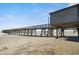 Wooden pier stretching over the beach and ocean under a clear blue sky on a sunny day at 6000 N Ocean Blvd. # 131, North Myrtle Beach, SC 29582