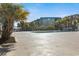 Outdoor swimming pool with ample deck space surrounded by palm trees and condo building at 6000 N Ocean Blvd. # 131, North Myrtle Beach, SC 29582