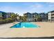 Community pool with sun loungers and palm trees surrounded by apartment buildings at 6000 N Ocean Blvd. # 131, North Myrtle Beach, SC 29582