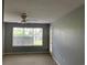 Bedroom with a view through a large window, ceiling fan, and direct patio access at 5020 Windsor Green Way # 103, Myrtle Beach, SC 29579