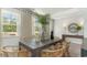 Bright dining room with wooden table, wicker chairs, and view of front yard at 120 Fair Meadow Ct., Loris, SC 29569