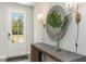 Light and airy entryway featuring a console table, decorative mirror, and stylish sconces at 120 Fair Meadow Ct., Loris, SC 29569