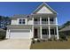 Charming two-story home with a double porch, white siding, and a well-manicured lawn at 120 Fair Meadow Ct., Loris, SC 29569