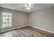 Spacious bedroom featuring hardwood floors, a ceiling fan, and a large window at 721 10Th Ave. S, Surfside Beach, SC 29575