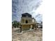 Exterior shot of a home under construction raised on stilts with yellow siding and a ladder at 721 10Th Ave. S, Surfside Beach, SC 29575