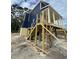 Exterior angle shot of a two story home being built on stilts with blue and yellow siding at 721 10Th Ave. S, Surfside Beach, SC 29575