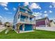 Side view of a stilt home features blue siding, white trim, and a door to ground-level storage at 721 10Th Ave. S, Surfside Beach, SC 29575
