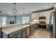 Open kitchen with stainless steel appliances, quartz counters, and decorative lighting at 721 10Th Ave. S, Surfside Beach, SC 29575