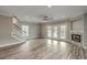 Bright living room featuring a fireplace, white trim, light gray walls, and glass doors leading outside at 721 10Th Ave. S, Surfside Beach, SC 29575