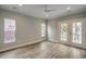Bright room featuring light gray walls, wood floors, windows, and glass patio doors at 721 10Th Ave. S, Surfside Beach, SC 29575