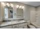 Well-lit bathroom with double sinks, granite countertop, modern lighting and a shower-tub combo at 723 10Th Ave. S, Surfside Beach, SC 29575