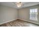 Cozy bedroom featuring a ceiling fan, light gray walls and wood grain laminate flooring at 723 10Th Ave. S, Surfside Beach, SC 29575