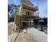 New construction home with a covered porch being built in a neighborhood with a dumpster at 723 10Th Ave. S, Surfside Beach, SC 29575