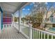 This outdoor deck features white railings and a view of nearby trees and houses at 723 10Th Ave. S, Surfside Beach, SC 29575