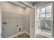 This laundry room features laminate flooring, a wire shelf, a window and a door at 723 10Th Ave. S, Surfside Beach, SC 29575