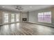 Spacious living room with a ceiling fan, fireplace, gray walls, and French doors at 723 10Th Ave. S, Surfside Beach, SC 29575