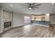 Spacious living room features wood floors, a stone fireplace, modern lighting, and kitchen breakfast bar at 723 10Th Ave. S, Surfside Beach, SC 29575