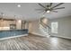 Open-concept living room featuring wood floors, modern lighting, and an adjacent kitchen with a breakfast bar at 723 10Th Ave. S, Surfside Beach, SC 29575