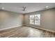 Room with wood floor and white trim featuring a large picture window at 723 10Th Ave. S, Surfside Beach, SC 29575